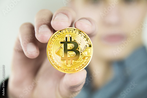 young businessman showing bitcoin photo