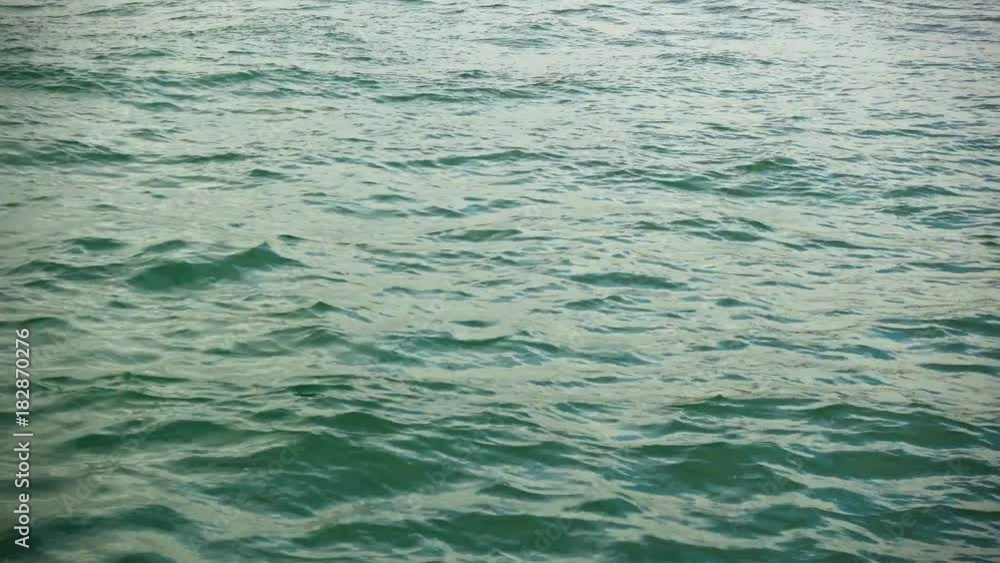 Sun glare on the water with a swell on the surface close-up Sun glare on the water with a swell on the surface close-up