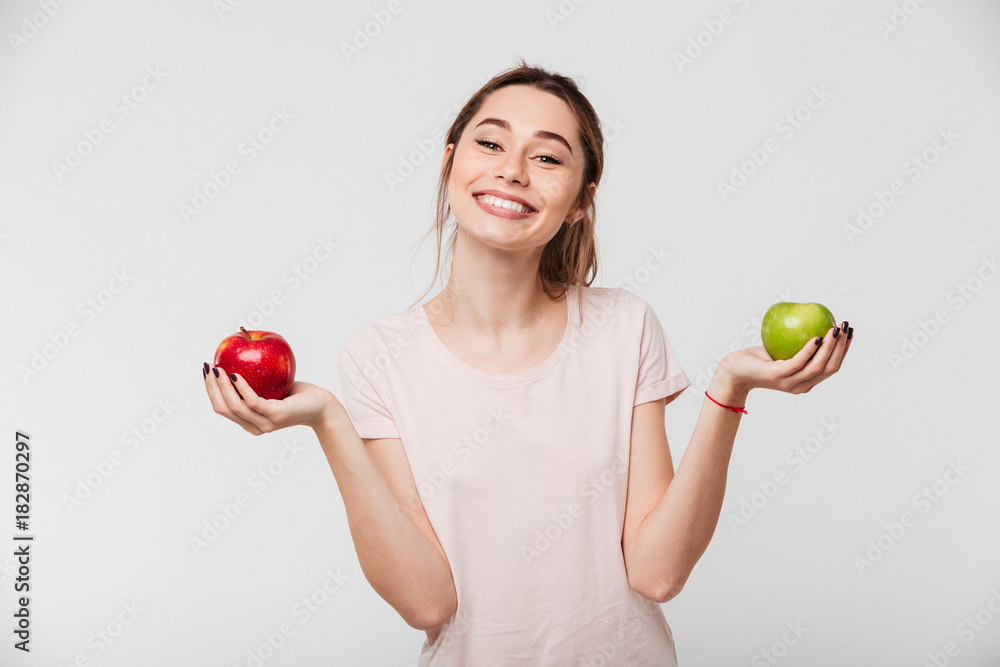 Portrait of a joyful happy girl holding apples Portrait of a joyful happy girl holding apples