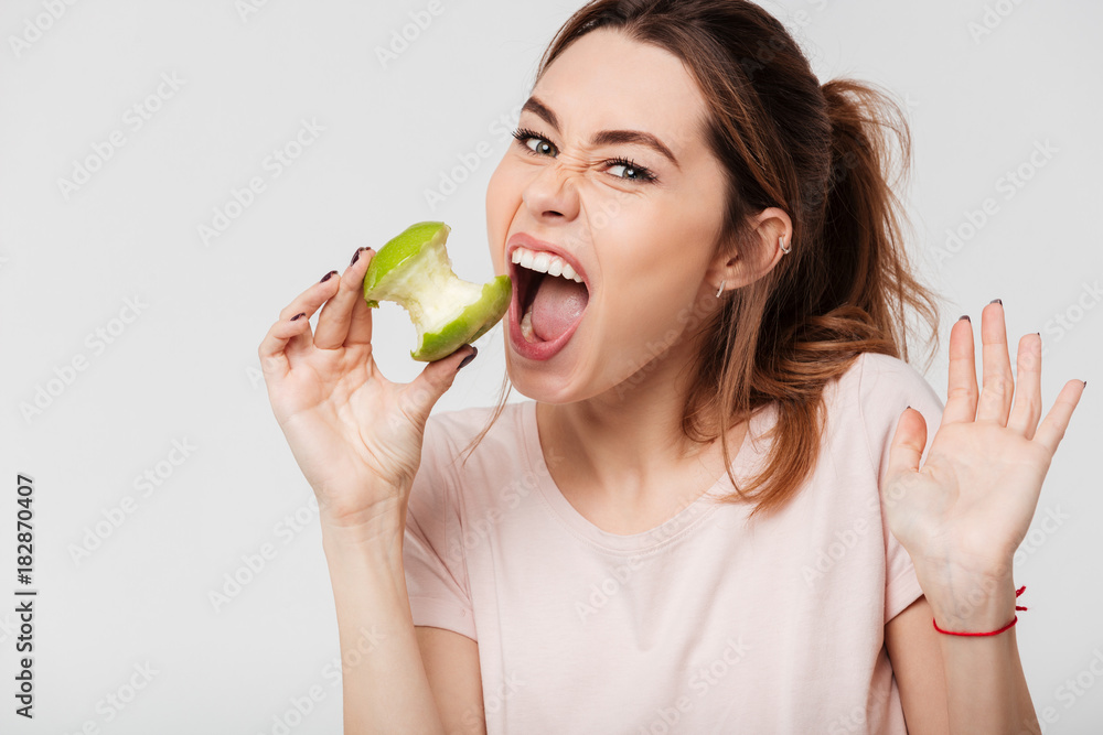 Close up portrait of a pretty girl biting an apple Close up portrait of a pretty girl biting an apple