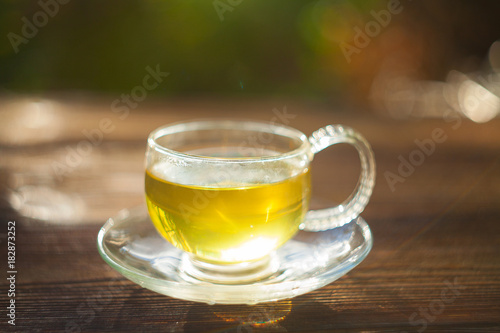 delicious green tea in beautiful glass bowl on table