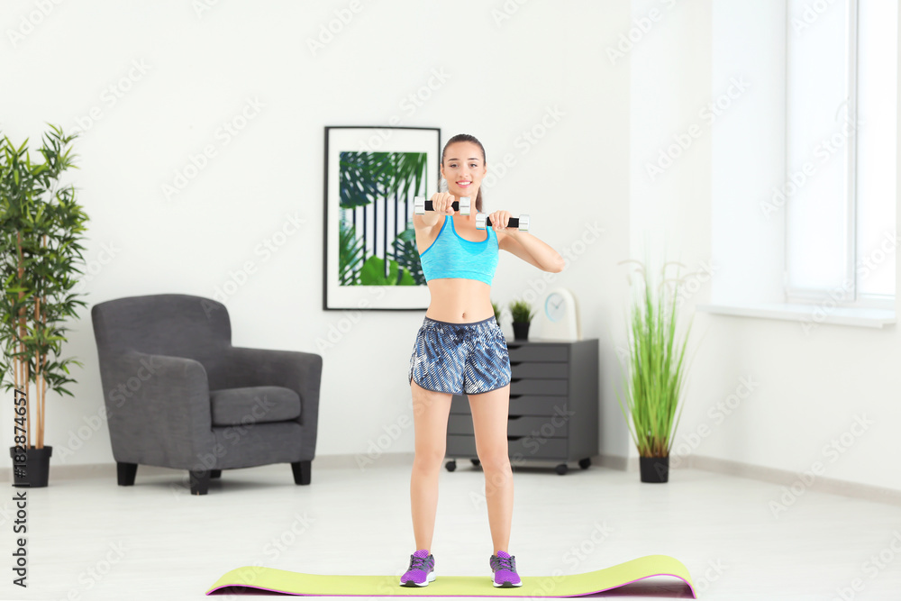 Sporty young woman training at home Sporty young woman training at home