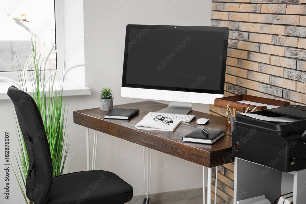 Comfortable workplace with computer monitor on table in office Comfortable workplace with computer monitor on table in office