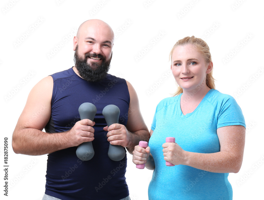 Overweight couple with dumbbells on white background Overweight couple with dumbbells on white background