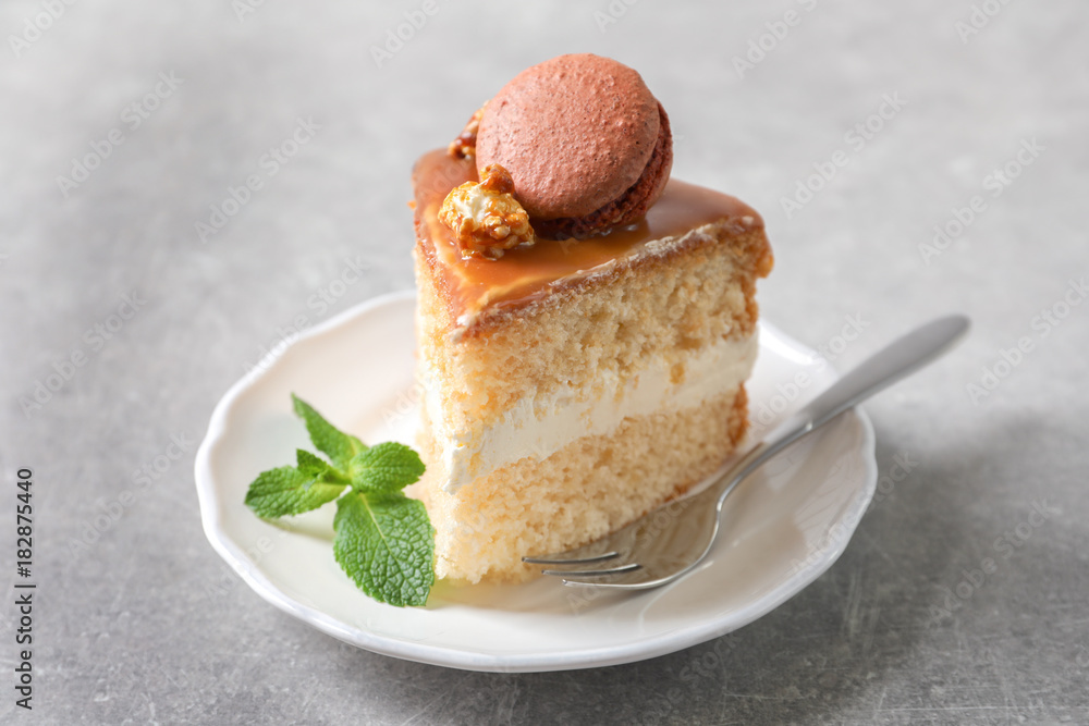Plate with piece of delicious caramel cake on table Plate with piece of delicious caramel cake on table