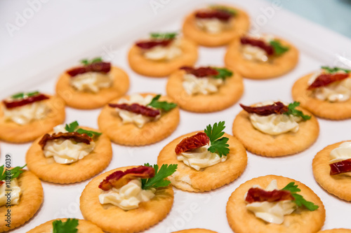 Cheese canape with chili on crackers