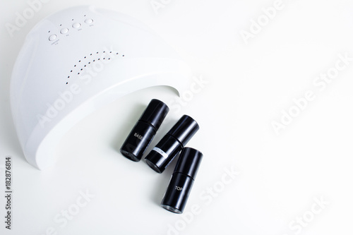 isolated background. manicure, coating with gel varnish. concepts of drying gel varnish in ultrafiolet lamp, UV lamp. 