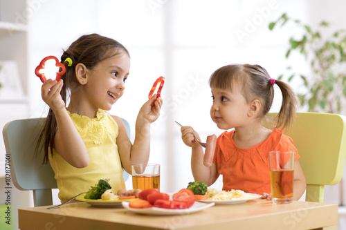 children eating food in kin...