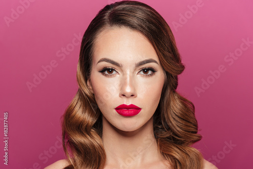 Young calm lady with make up looking camera isolated
