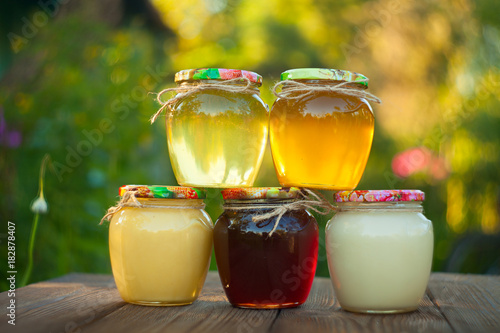 Delicious delicious honey in  jar on table