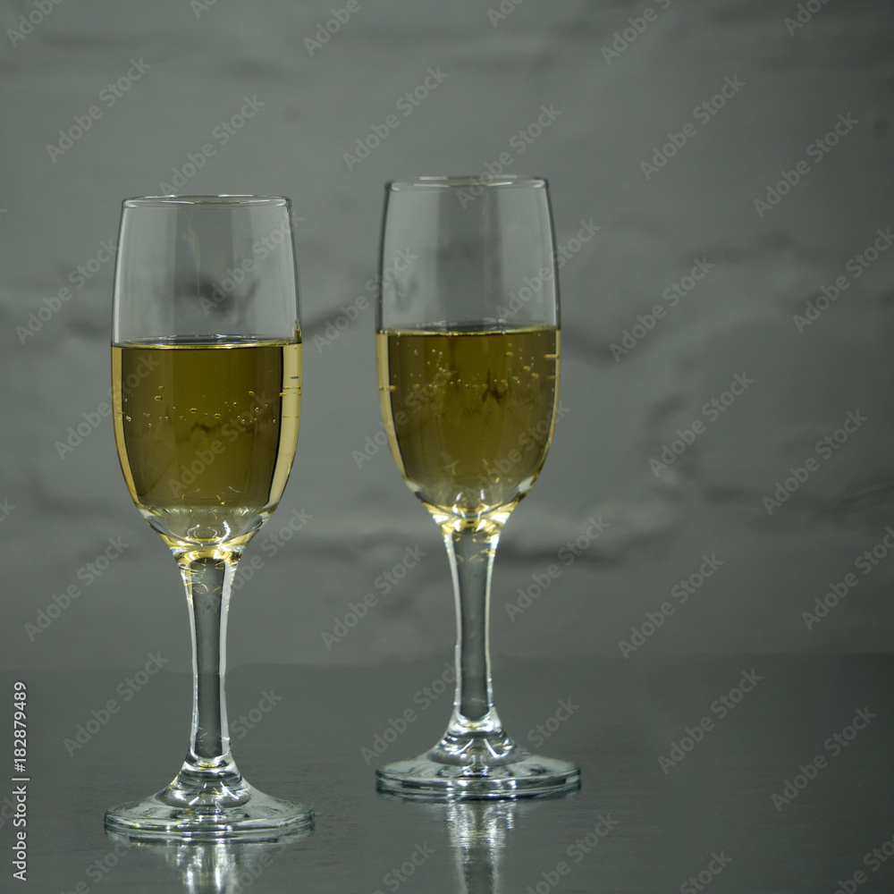 two glasses of champagne on white background
