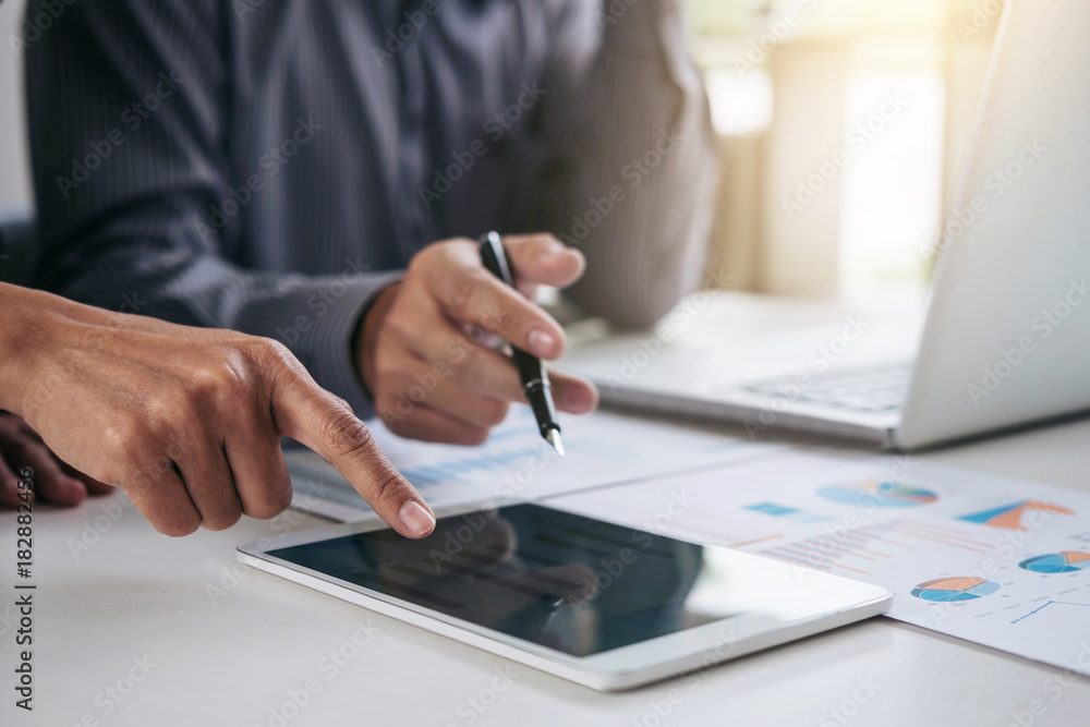 Teamwork process, Business adviser analyzing financial figures denoting the progress in the work of the company Teamwork process, Business adviser analyzing financial figures denoting the progress in the work of the company