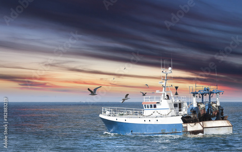 Ready to work, small fisherman ship toward the sea early in the morning