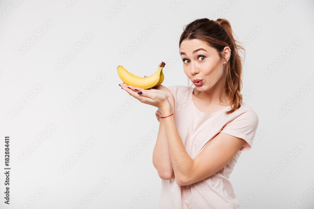 Portrait of a lovely young girl holding bananas Portrait of a lovely young girl holding bananas