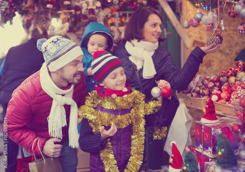 Charming parents with children with Christmas decoration