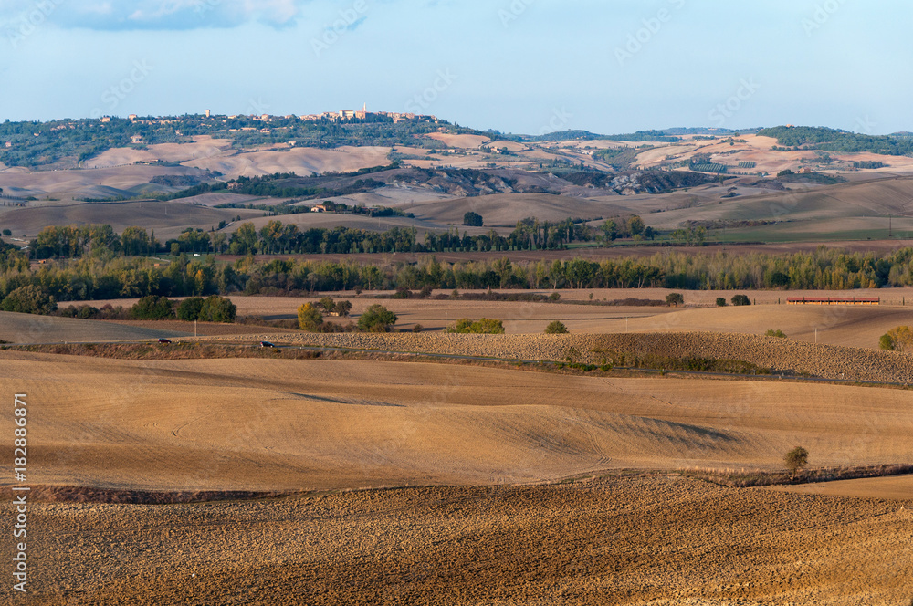 Beautiful rural autumn landscape of Val d'Orcia on the background Pienza, Tuscany, Italy.