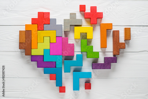 Heart made of colorful wooden shapes  top view  flat lay.