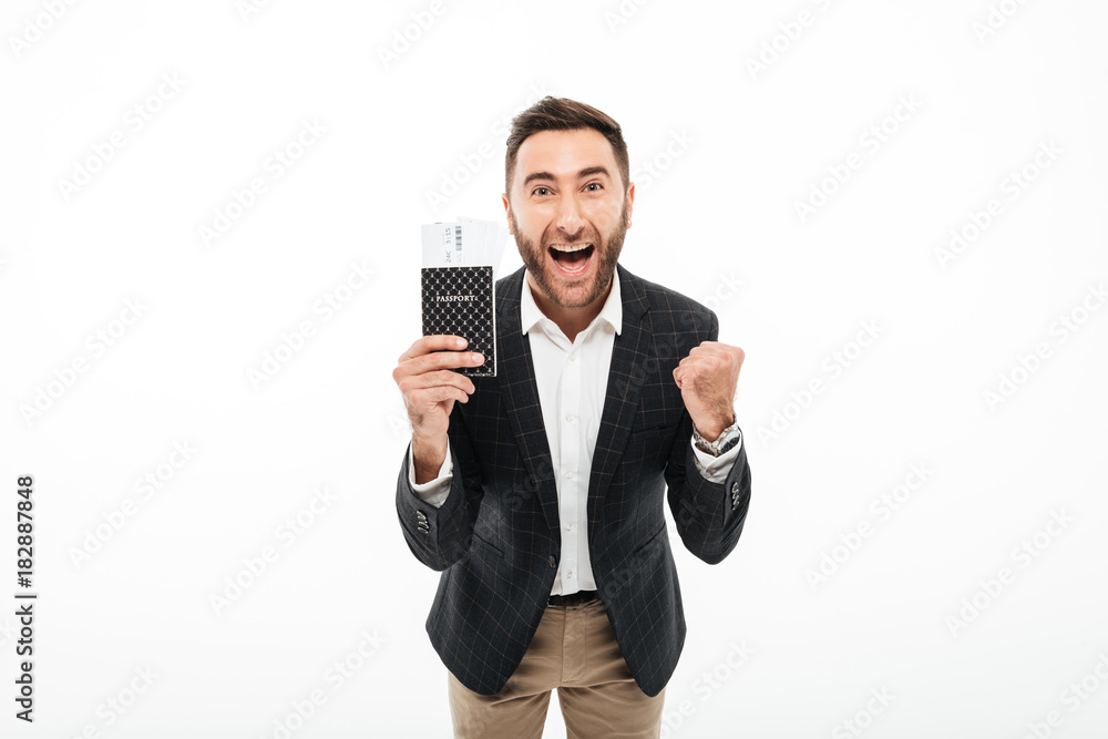 Portrait of a cheerful excited man holding passport Portrait of a cheerful excited man holding passport
