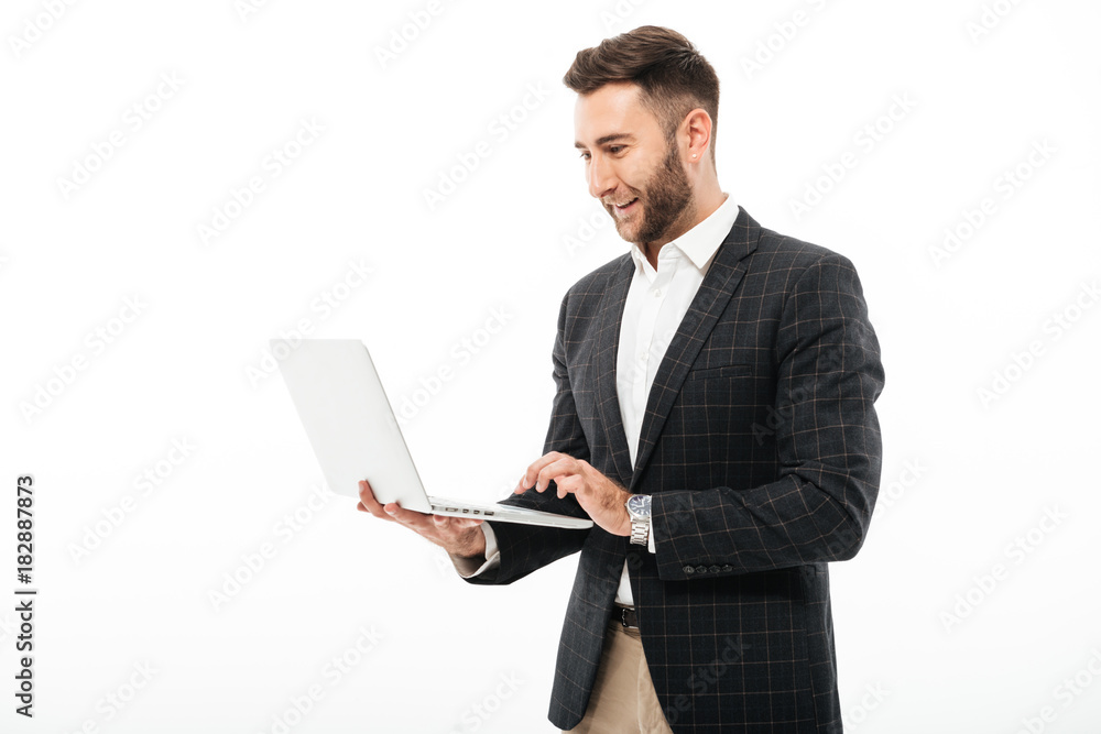 Portrait of a confident bearded man using laptop computer Portrait of a confident bearded man using laptop computer