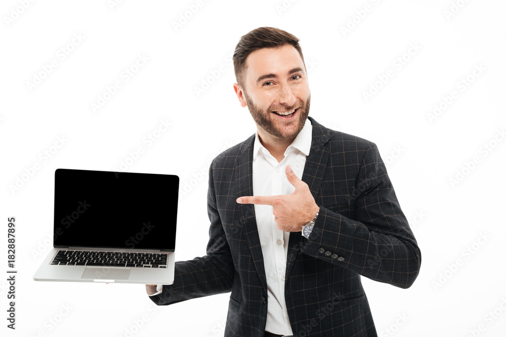 Portrait of a cheerful bearded man pointing finger Portrait of a cheerful bearded man pointing finger