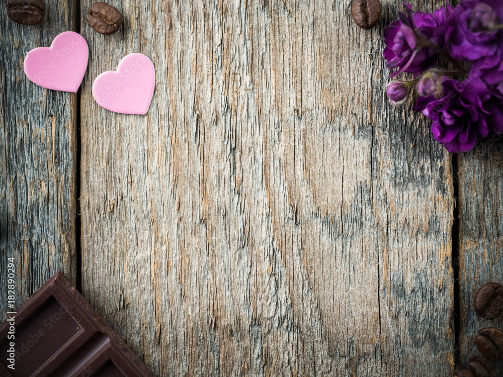 Fototapeta premium Decorations for Valentines day paper hearts, violets and chocolate coffee on rustic wooden background