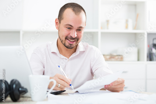 Positive young man in office photo