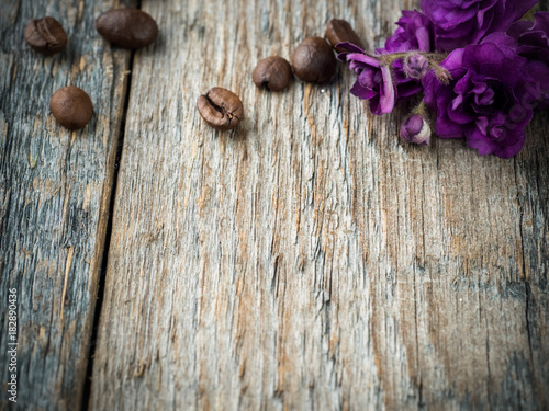 Decorations for Valentines day violets and chocolate coffee on rustic wooden background