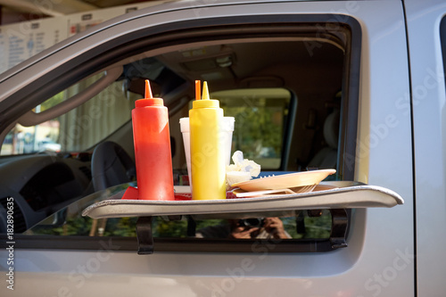 Slika na platnu Portable car table with condiments at a takeaway