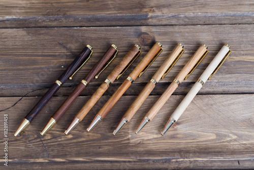 wooden writing pens on a wooden table