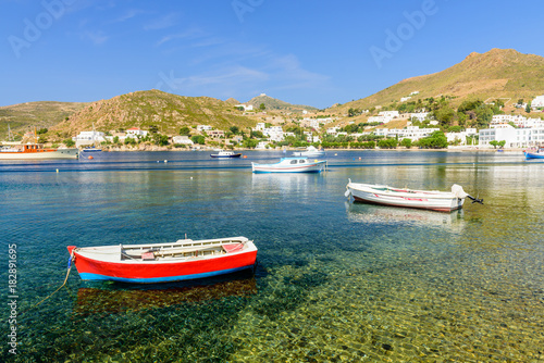 Colorful fishing boats in the picturesque Bay of Grikos, a popular tourist site on the island of Patmos, Dodecanese, Greece 