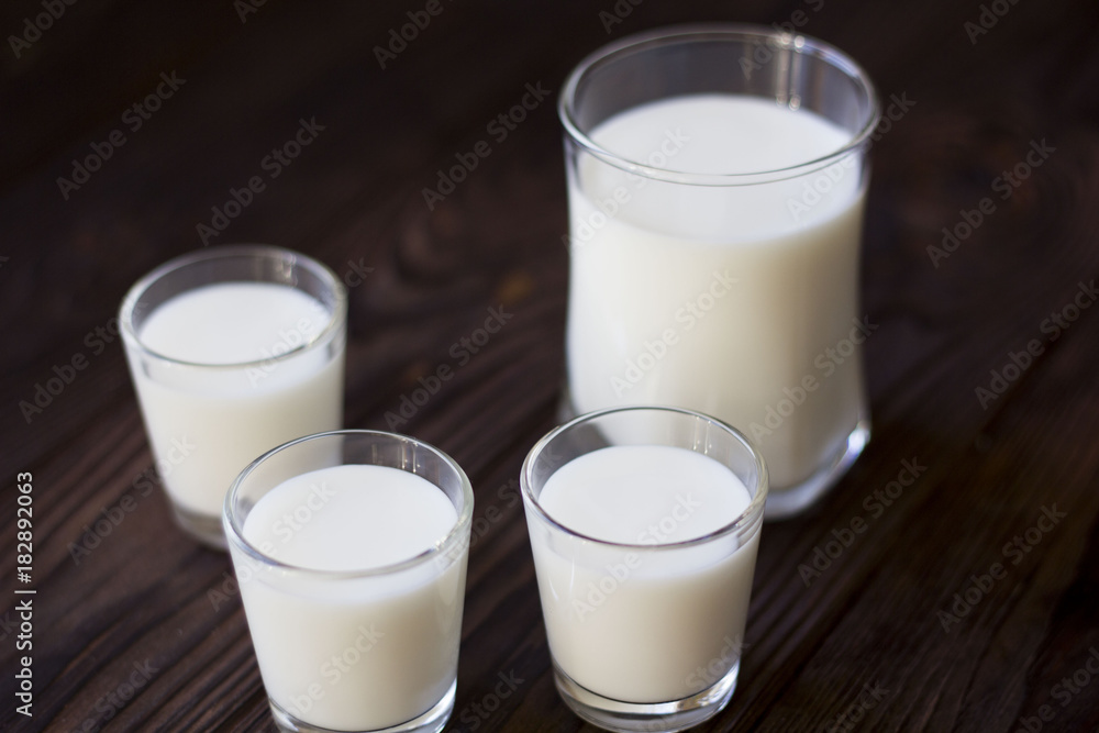 rustic dairy products, glass of milk on a wooden table