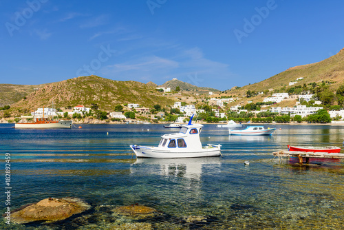 Colorful fishing boats in the picturesque Bay of Grikos, a popular tourist site on the island of Patmos, Dodecanese, Greece  photo