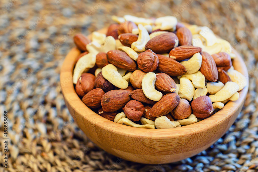 Assorted nuts in wooden bowl Assorted nuts in wooden bowl