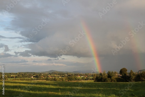 Beautiful landscape with rainbow. Czech typical summer landscape.