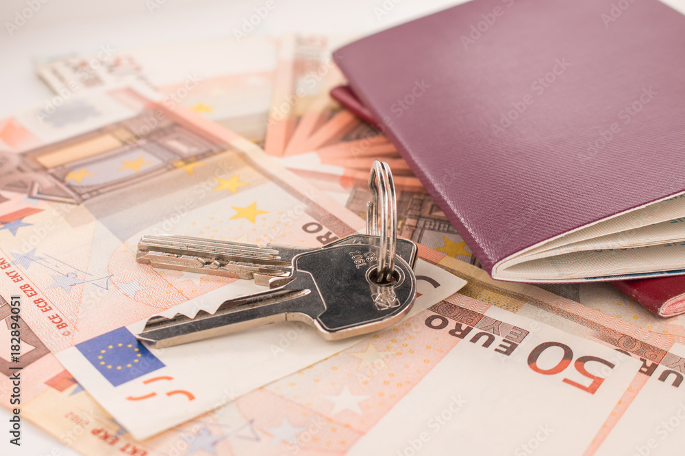 Passports on banknote background. Passports and keys of house. Euro banknotes 50 fifty. Traveling and money. Passports on banknote background. Passports and keys of house. Euro banknotes 50 fifty. Traveling and money.
