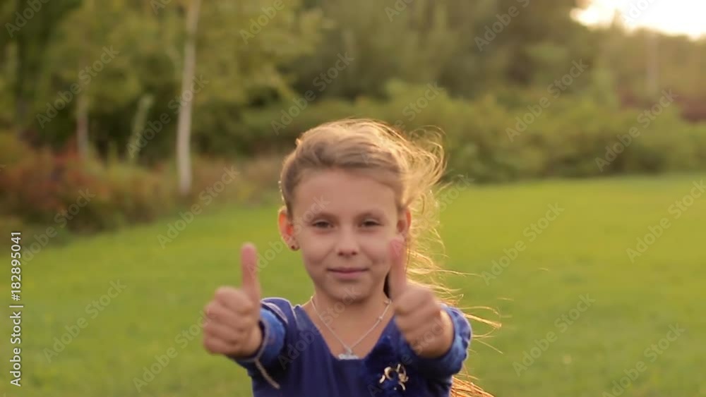Little girl is happy and showing thumb up Little girl is happy and showing thumb up