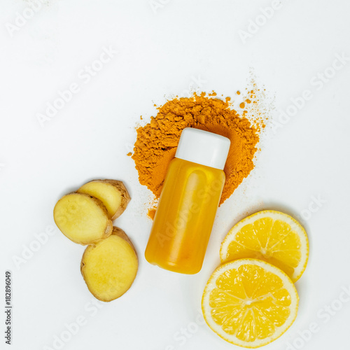 Ginger shot healthy drink with curd in a plastic bottle on white background. Immunity Boosting Tonic. Top view