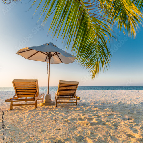 Fototapeta Naklejka Na Ścianę i Meble -  Beautiful beach. Chairs on the sandy beach near the sea. Summer holiday and vacation concept. Inspirational tropical scene. Tranquil scenery, relaxing tropical landscape design