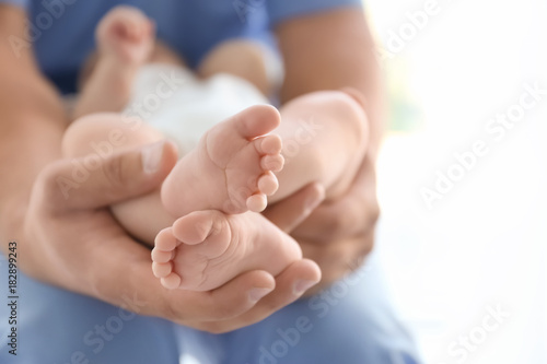 Konstfotografi Male doctor holding baby at hospital