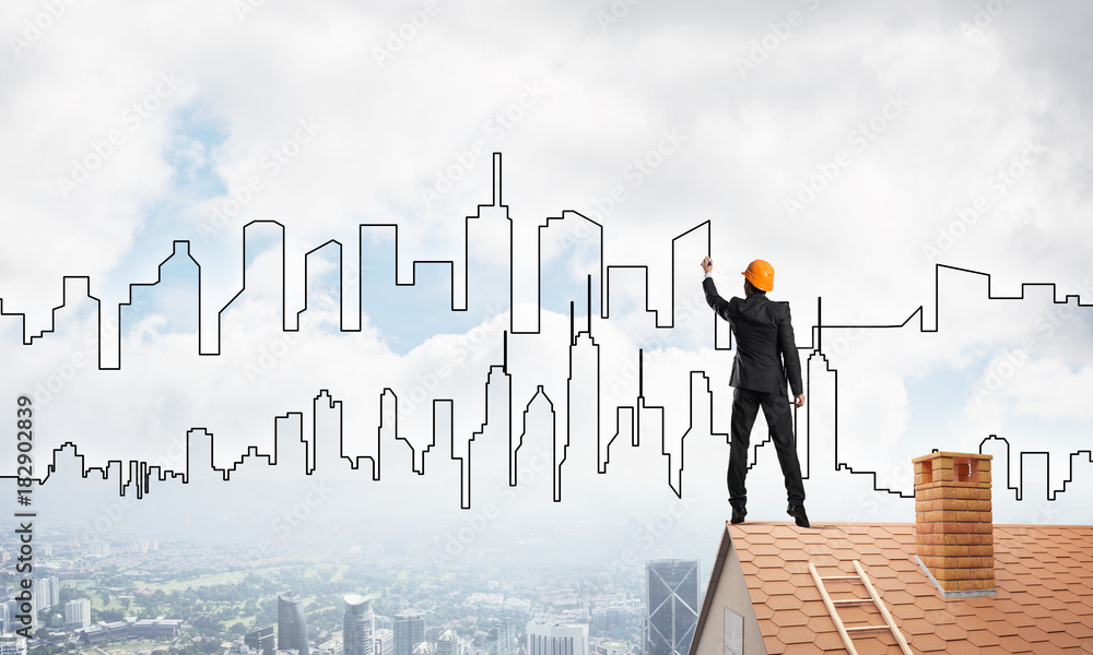 Man architect draw silhouette of modern city on blue sky. Mixed media Man architect draw silhouette of modern city on blue sky. Mixed media