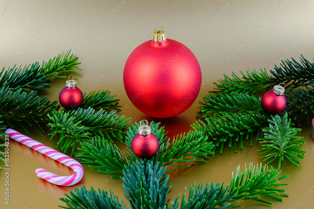 Fototapeta premium Christmas composition with red Christmas ball and fir branches.
