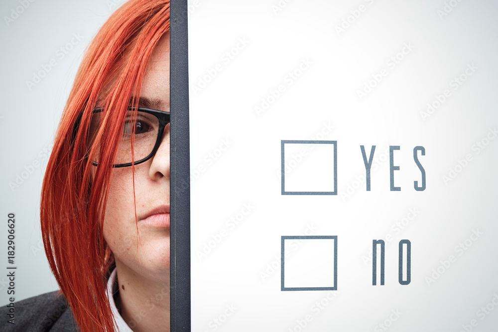 Business concept of choice and voting. A woman in a suit and glasses makes a yes or no choice. With a place for advertising text. Chef Day, Boss Day, Elections Business concept of choice and voting. A woman in a suit and glasses makes a yes or no choice. With a place for advertising text. Chef Day, Boss Day, Elections