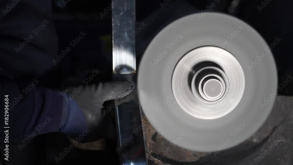 Polishing stainless steel. The master is working on the polishing machine. Polishing stainless steel. The master is working on the polishing machine.
