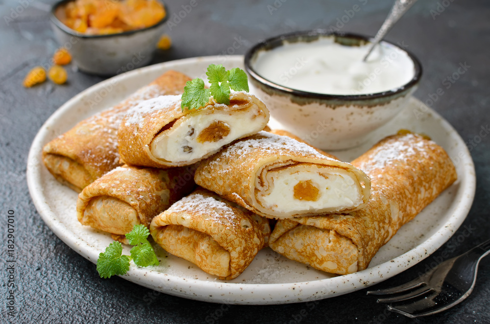 Pancakes stuffed with cottage cheese and raisins
