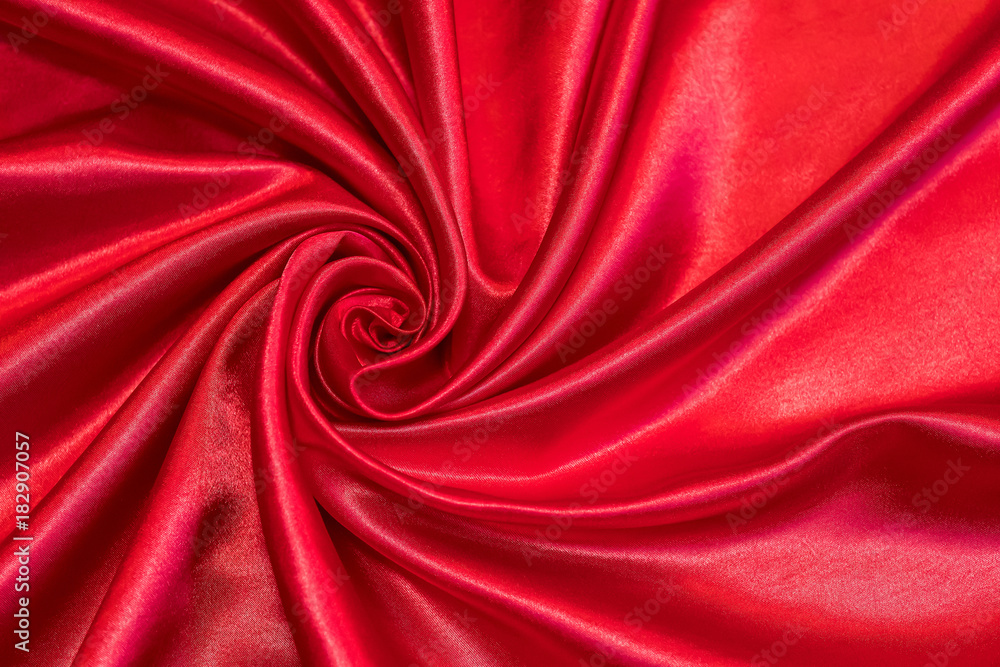 Fototapeta premium The red fabric is formed in the form of a rose.