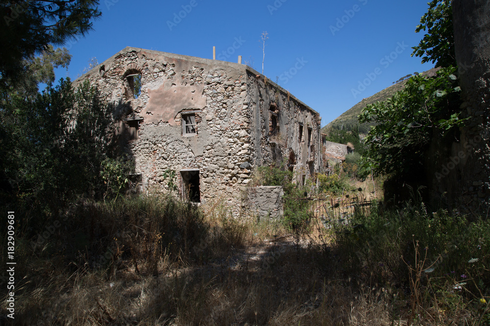 Entrance to a deserted village recaptured by nature in the Nature Reserve Laghetti di Marinello