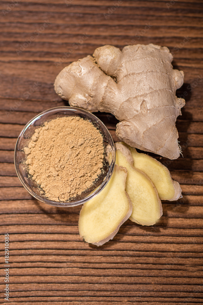 close up of a fresh ginger root on an old wood background close up of a fresh ginger root on an old wood background