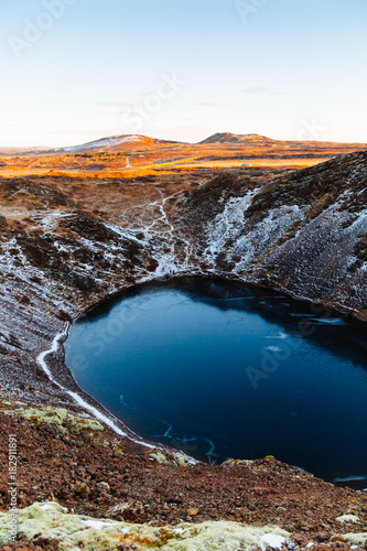 Top view of the Kerid crater with blue lake at sunrise. The Golden Circle tour. Iceland landscape.