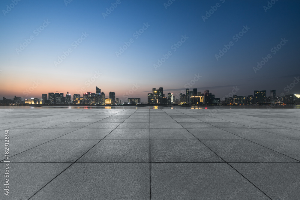 night view of empty brick floor front of modern building