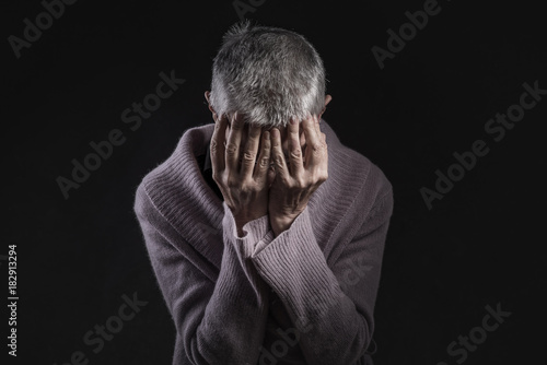 Quadro su tela Senior old woman in despair with hands over her head, feeling lonely and abandon